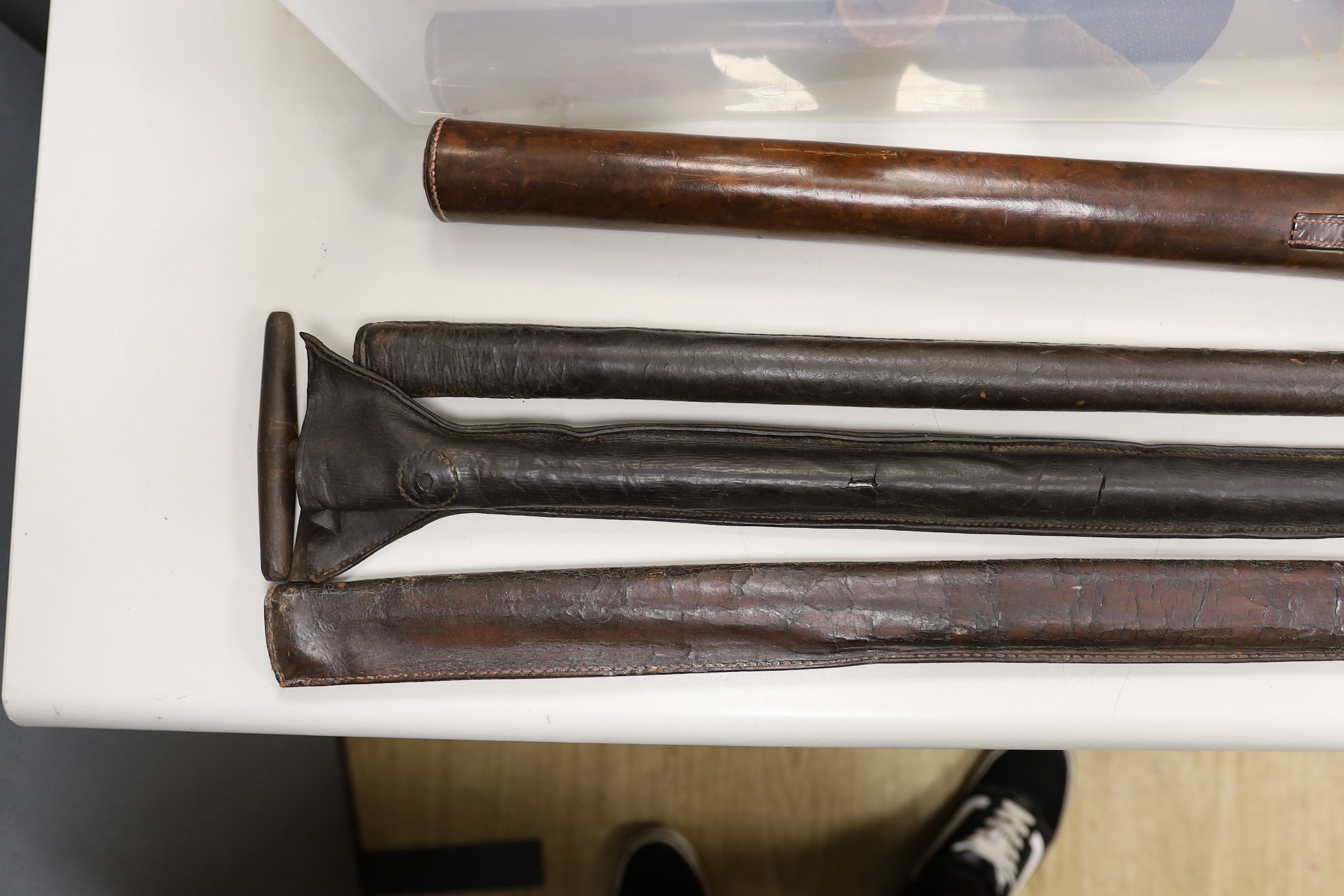 Four Victorian surveyors measuring rods, in leather cases